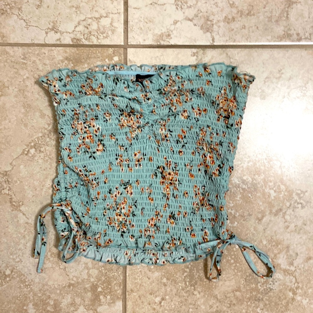 Turquoise tube top with orange floral pattern and adjustable ties on the sides.